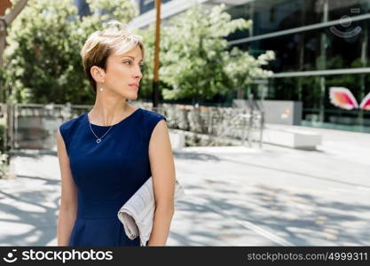 Businesswoman standing next to her office in the morning. New business day is coming and I am ready for it