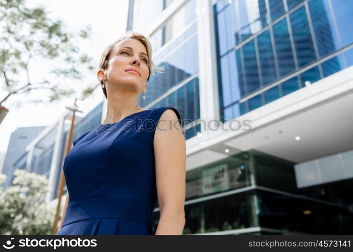 Businesswoman standing next to her office in the morning. New business day is ahead