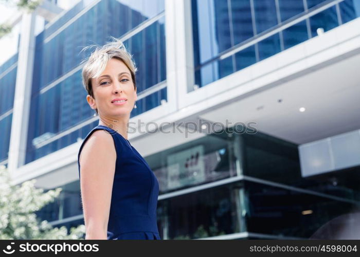 Businesswoman standing next to her office in the morning. New business day is ahead