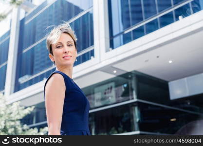 Businesswoman standing next to her office in the morning. New business day is ahead