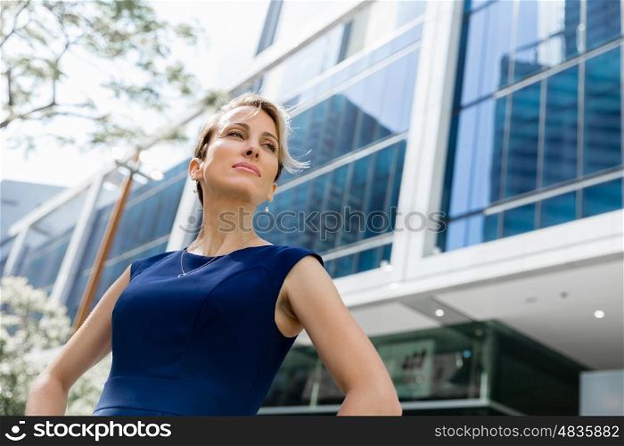 Businesswoman standing next to her office in the morning. New business day is ahead