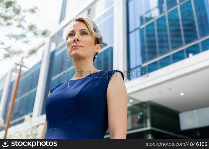 Businesswoman standing next to her office in the morning. New business day is ahead