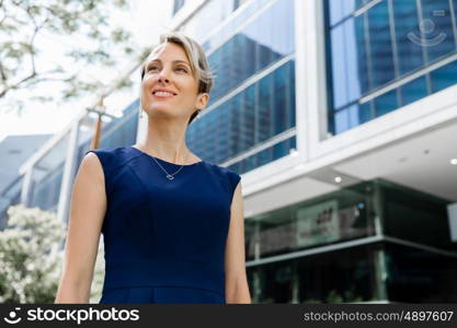 Businesswoman standing next to her office in the morning. New business day is ahead