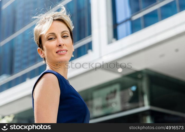 Businesswoman standing next to her office in the morning. New business day is ahead