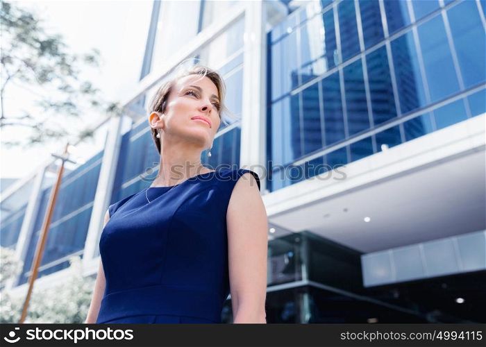 Businesswoman standing next to her office in the morning. New business day is ahead
