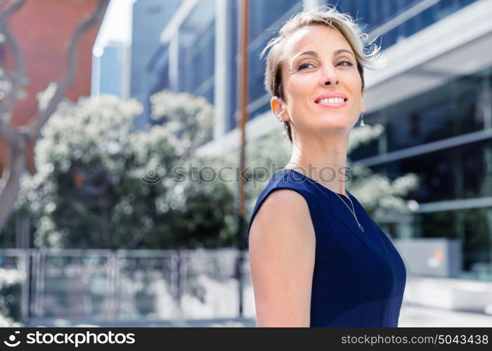 Businesswoman standing next to her office in the morning. New business day is ahead