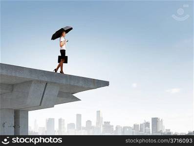 Businesswoman standing on bridge