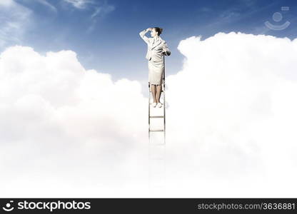 Businesswoman standing on ladder looking into distance against cloudy background