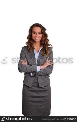 Businesswoman standing on white background with arms crossed