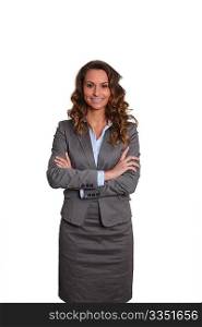 Businesswoman standing on white background with arms crossed