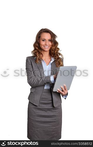 Businesswoman standing on white background with touchpad
