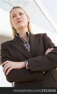 Businesswoman standing outdoors by building