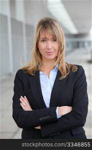 Businesswoman standing outside with arms crossed