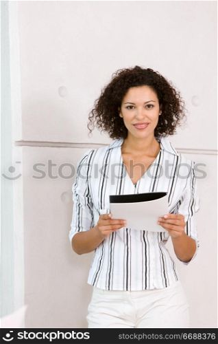 businesswoman standing up reading a document