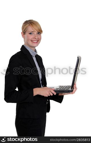 Businesswoman standing with a laptop