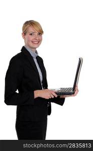 Businesswoman standing with a laptop
