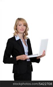 Businesswoman standing with her laptop.