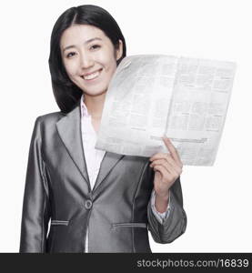 Businesswoman standing with newspaper