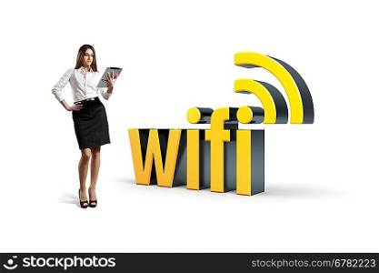 Businesswoman stands with tablet pc by the wifi word. Isolated.