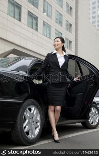 Businesswoman stepping out a car