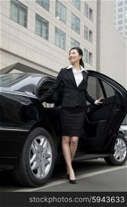 Businesswoman stepping out a car