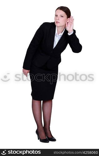 Businesswoman straining her ear