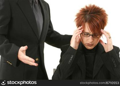 Businesswoman suffering from a headache with a businessman standing beside her