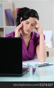 Businesswoman suffering from migraine