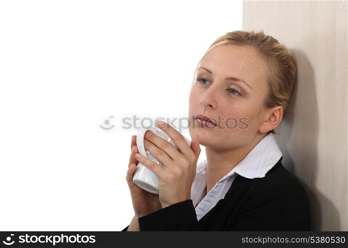 Businesswoman taking five minutes with a hot drink
