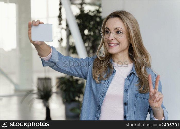 businesswoman taking selfie work