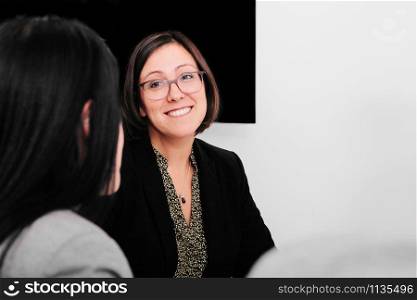 Businesswoman talking in front of her colleagues in the office