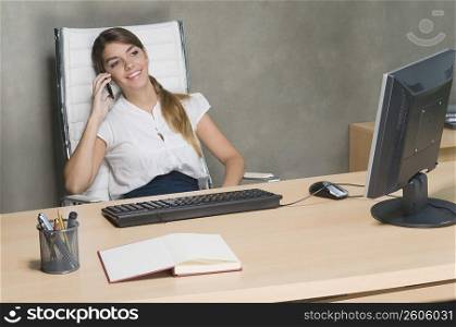 Businesswoman talking on a mobile phone in an office