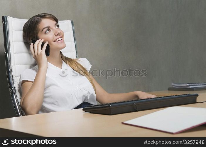 Businesswoman talking on a mobile phone in an office