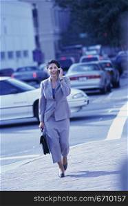 Businesswoman talking on a mobile phone smiling