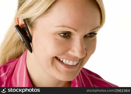 Businesswoman Talking On Hands Free Phone