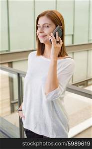 businesswoman talking on mobile phone in office building