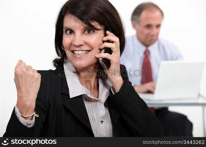 businesswoman talking on phone and receiving very good news