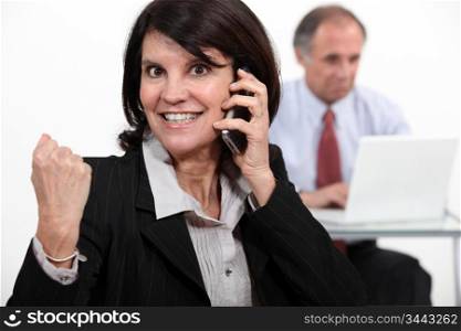 businesswoman talking on phone and receiving very good news