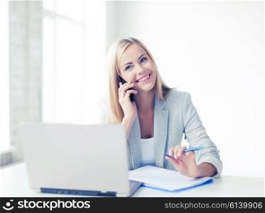businesswoman talking on the phone and taking notes. businesswoman with phone