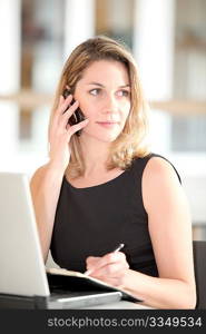 Businesswoman talking on the phone in the office