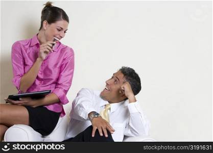 Businesswoman talking to a businessman