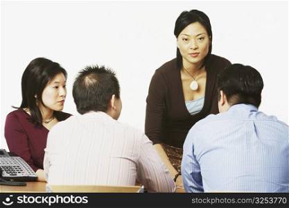 Businesswoman talking to her colleagues in a conference room