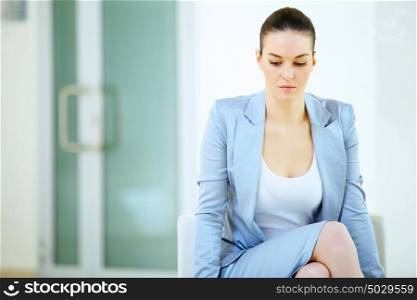 businesswoman thinking. a portrait of attractive young businesswoman thinking in office