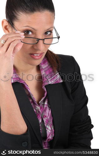 Businesswoman tipping glasses