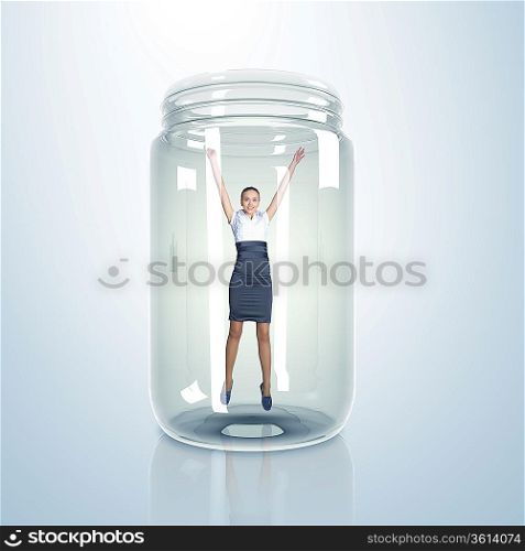 Businesswoman trapped inside a transparent glass jar