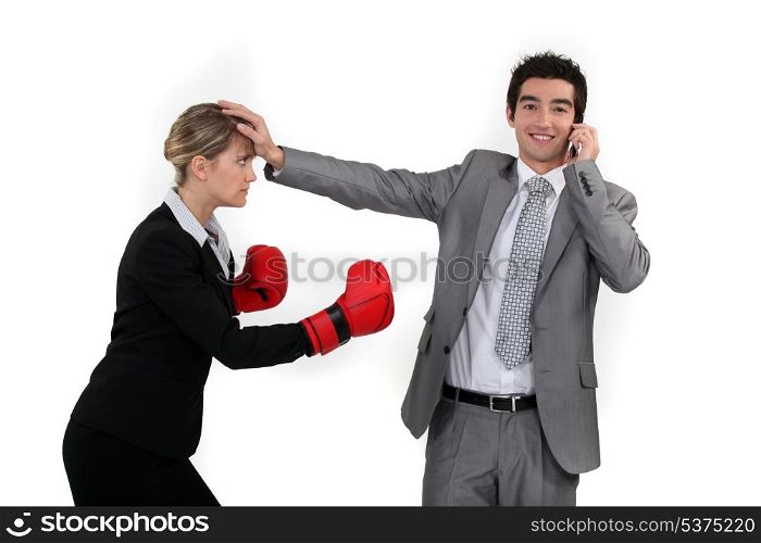 Businesswoman trying to box a man on a phone