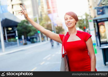 Businesswoman trying to catch a taxi. Businesswoman trying to catch a taxi in business city district