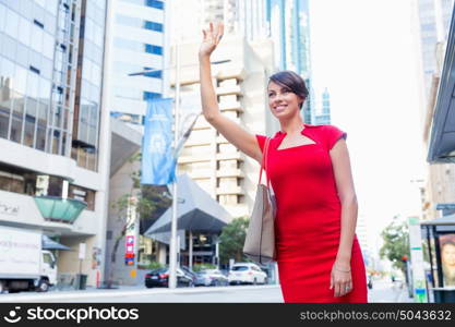 Businesswoman trying to catch a taxi. Businesswoman trying to catch a taxi in business city district