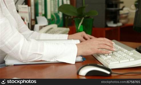 Businesswoman typing in an office