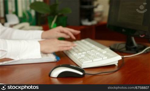 Businesswoman typing in an office focus on computer mouse